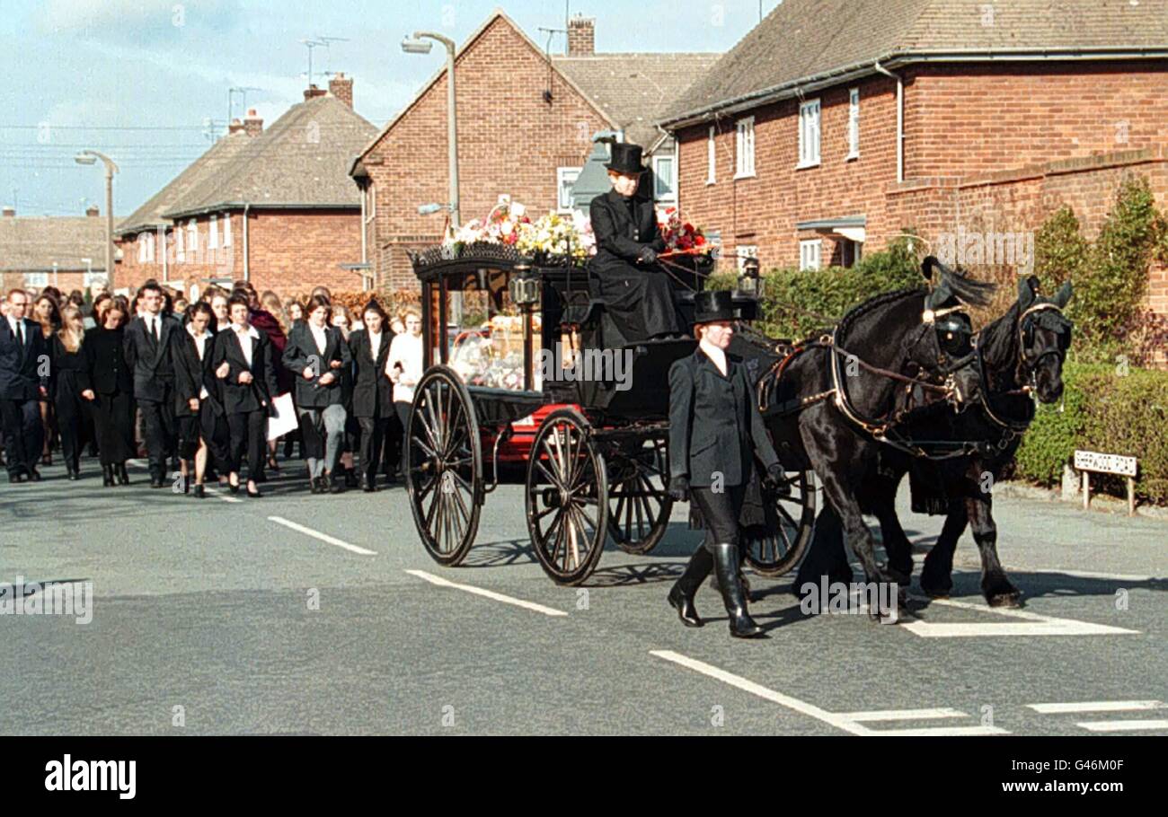 El corazón tirado por caballos de la asesinada colegiala de Chester Kayleigh Ward pasa por las calles de Blacon, Chester, seguido por su familia, (mamá Yvonne está sosteniendo una tarjeta blanca), y amigos hoy (martes). Kayleigh, de nueve años, desapareció antes de Navidad después de salir a comprar patatas fritas. Su cuerpo estrangulado fue descubierto justo sobre la frontera galesa desde la histórica ciudad el mes pasado. Foto de Dave Kendall. VER HISTORIA DE LA AP FUNERAL KAYLEIGH. Foto de stock