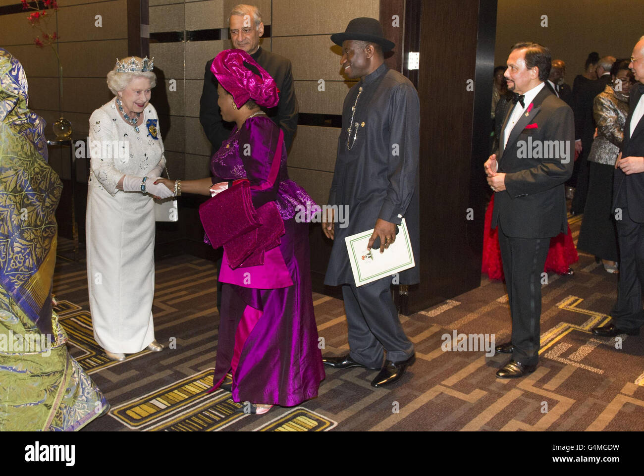 La Reina Isabel Ii De Gran Bretana Sacude Las Manos Con Paciencia Jonathan La Esposa Del Presidente De Nigeria Goodluck Jonathan Centro Vigilada Por El Sultan De Brunei Derecha En Un Banquete