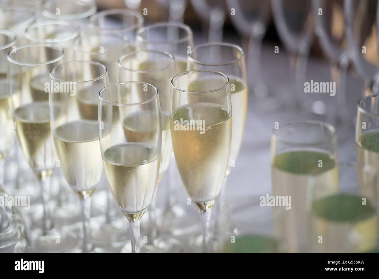 Champaña servido en copas de una botella durante una recepción con champán. Foto de stock