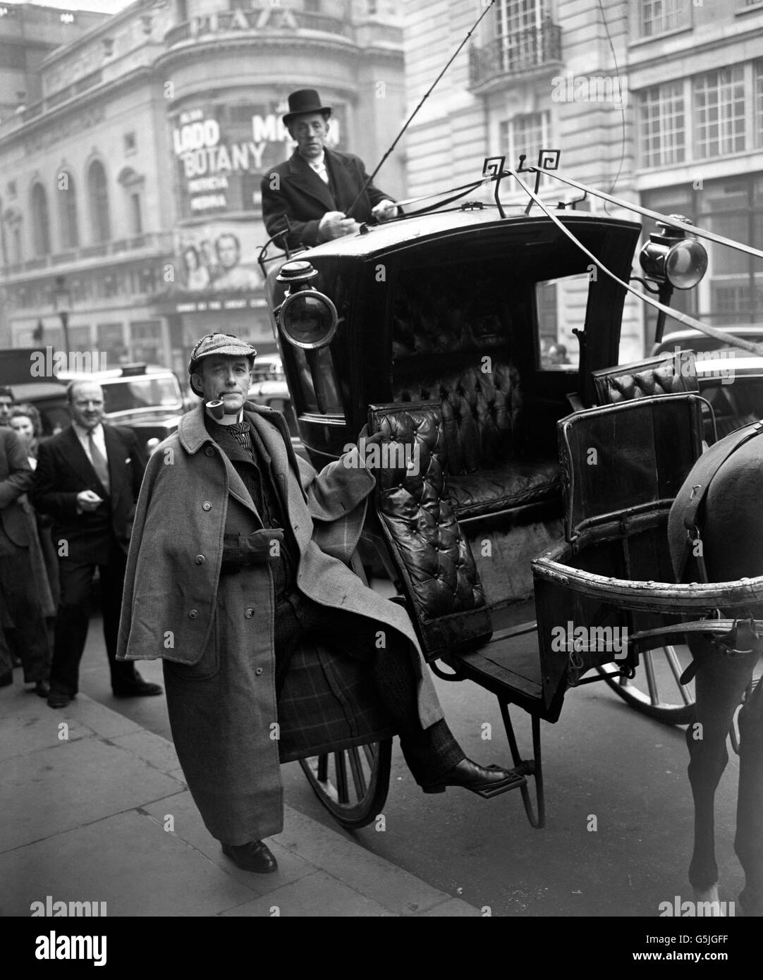 El actor inglés Carleton Hobbs, vestido como el mundialmente famoso detective Sherlock Holmes de Sir Arthur Conan Doyle, es llevado en un taxi de hansom al restaurante Criterion en Piccadilly Circus, Londres. Es testigo de la desvela de una placa que registra el encuentro de su personaje con el Dr. Watson en la larga barra de allí en 1851. Foto de stock