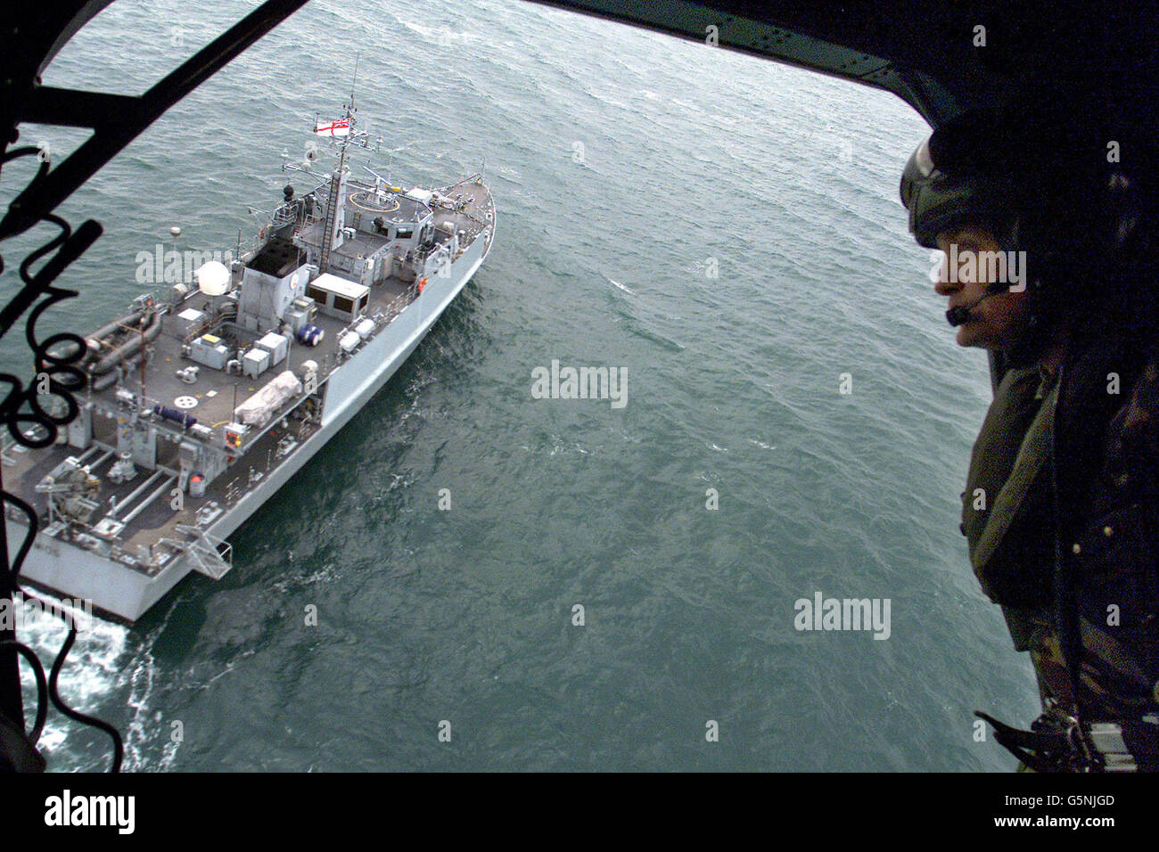 El cazador de minas de la Royal Naval HMS Bridport, visto desde un helicóptero de la Royal Navy, en la búsqueda de los cadáveres que se ahogaron durante un viaje de pesca. Michael Greene, de 54 años, su hijo de 32 años y su nieto de ocho años, también llamado Michael, desapareció el 14/2/02. * después de que se fueron de Kilkeel, Co Down, para pescar gambas. * 25/03/2002: Los buzos de policía esperaban reanudar la búsqueda. Se enviaron a Irlanda del Norte equipos y cámaras de vigilancia subacuática especializados para ayudarles a estudiar los restos del barco de pesca, que finalmente se encontraba a 130 pies sobre el fondo del mar a siete millas de su puerto de origen Foto de stock