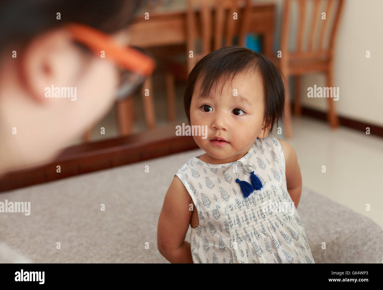 Una niña china de dos años, grandes ojos miró a su madre Foto de stock
