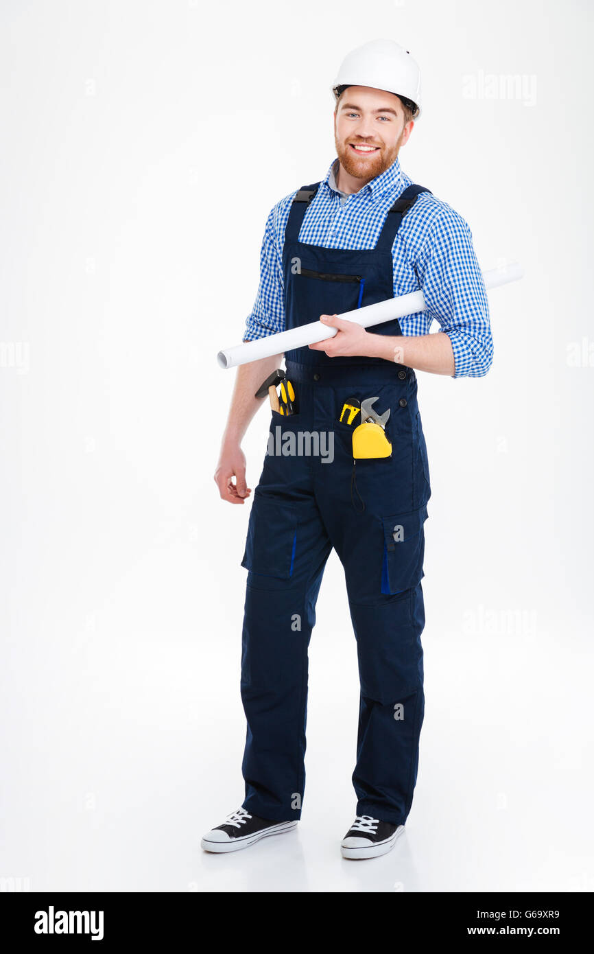 Generador de confianza que los jóvenes alegres en el casco y la celebración permanente blueprints Foto de stock
