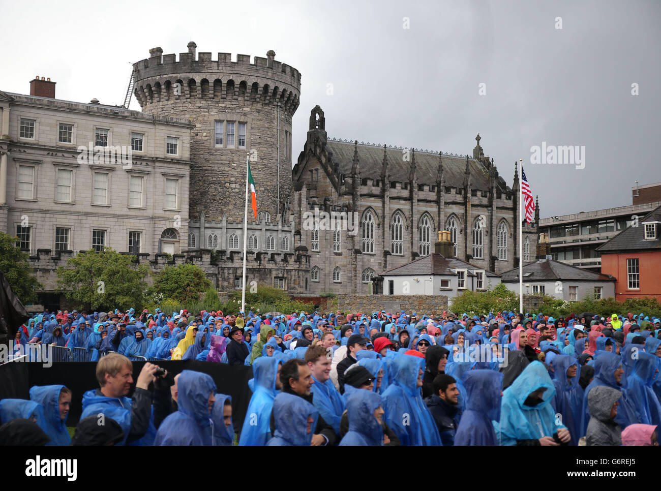 La gente espera en la lluvia para escuchar el vicepresidente estadounidense Joe Biden hablando en el Castillo de Dublín. Foto de stock