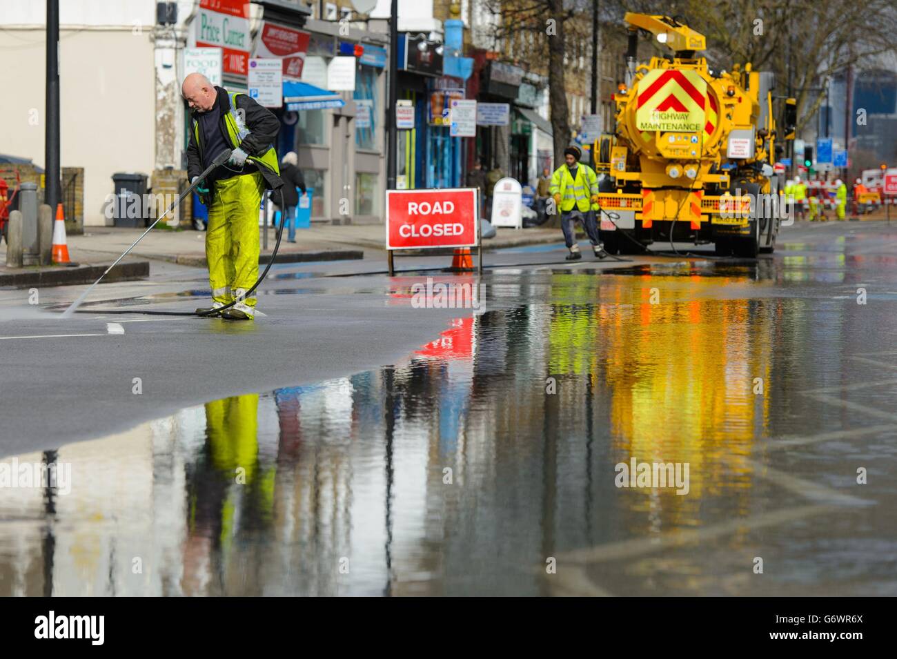 El esfuerzo de limpieza tras las inundaciones en Clapham Road, en Kennington, al sur de Londres, como resultado de una explosión de agua principal. Foto de stock