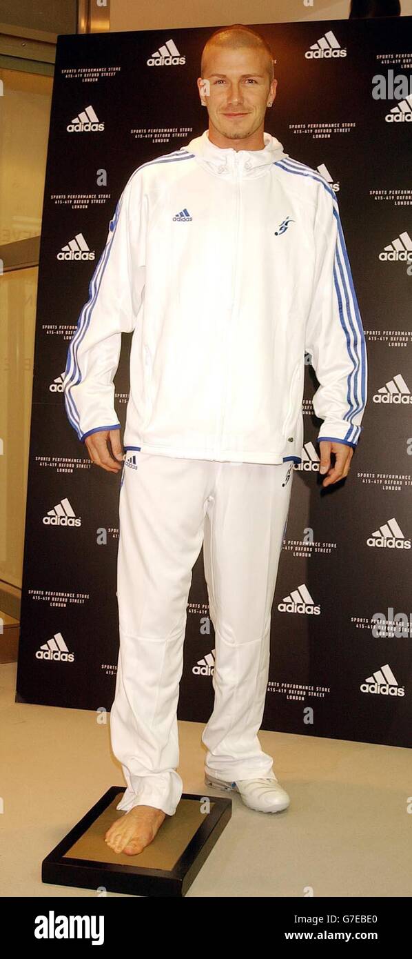 El futbolista del Real Madrid e Inglaterra David Beckham está parado en un  molde para hacer un molde de hormigón de su pie derecho en la tienda Adidas  en Oxford Street, Londres.