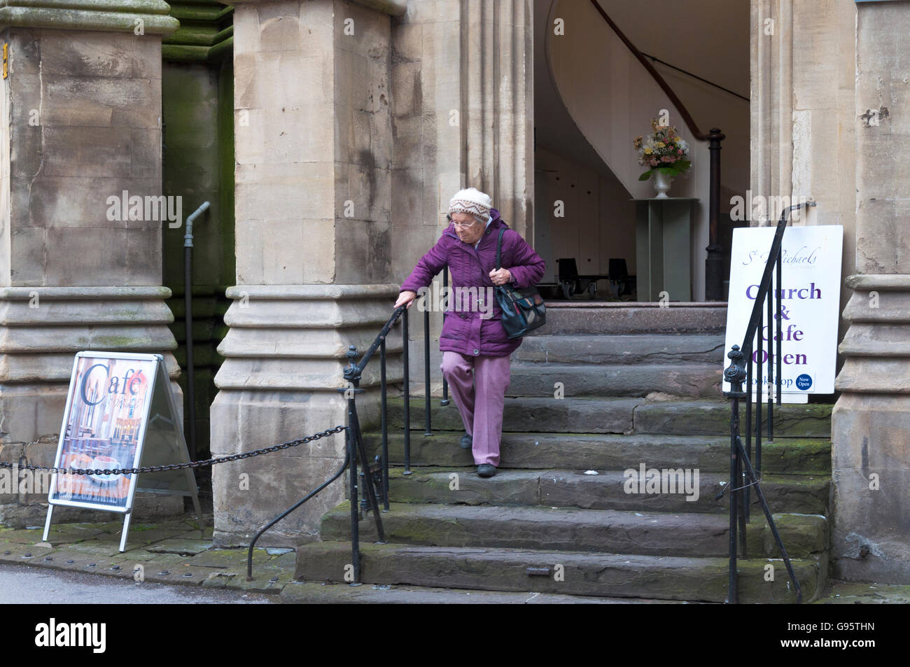 Una anciana mujer mayor deje el Cafe en St Michaels sin iglesia en Bath, Somerset, Inglaterra, Reino Unido. Foto de stock