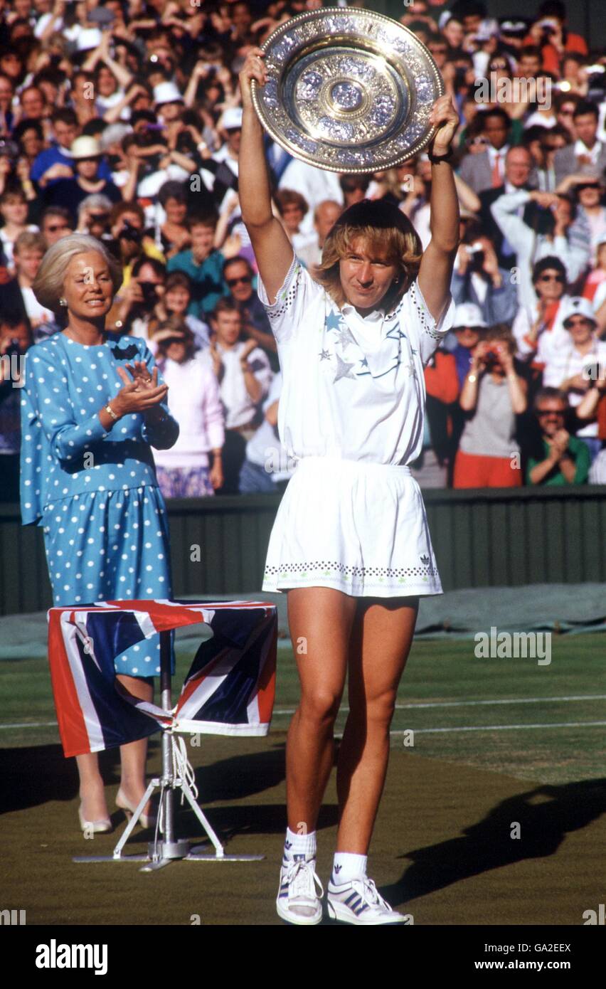 Steffi Graf levanta el trofeo de las Damas' Singles después de su victoria de tres, como la duquesa de Kent (l) muestra su aprecio Foto de stock