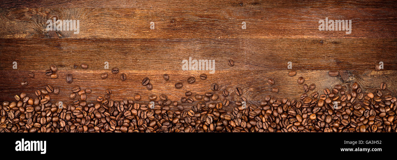 Los granos de café en gran fondo de roble rústico Foto de stock