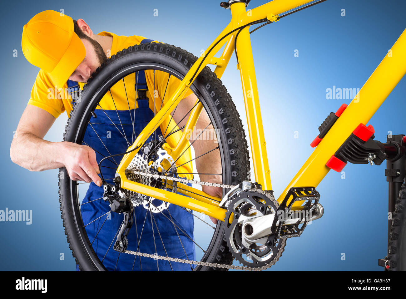 Trabajo mecánico de bicicletas en bicicleta de montaña amarilla Foto de stock
