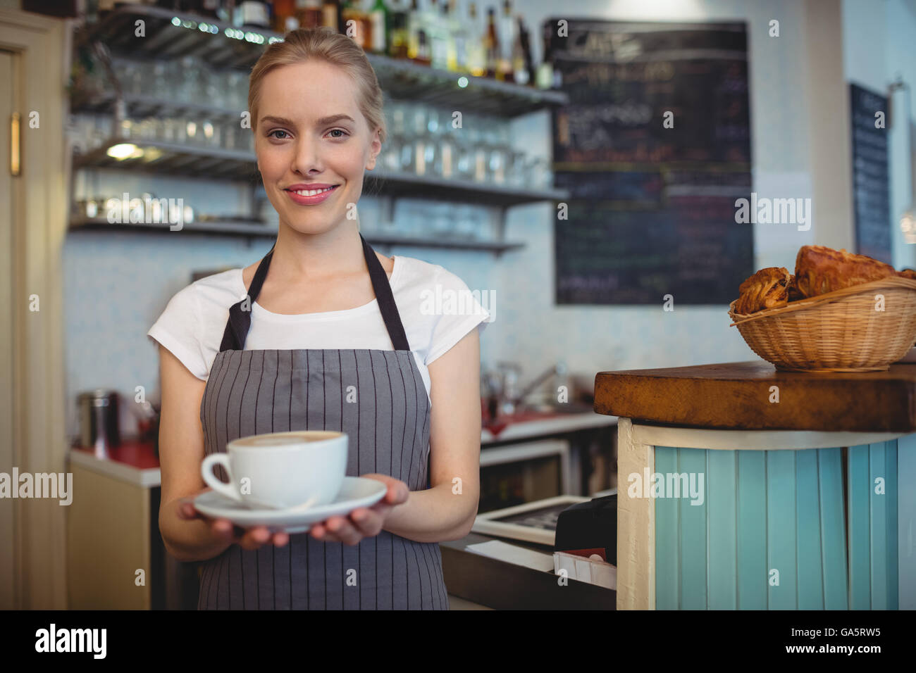 Retrato de feliz camarera sirviendo bebidas en el café Foto de stock