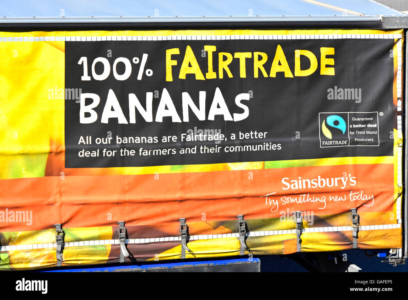 Closeup anuncio en el lateral del Sainsburys logística de la cadena de suministro de transporte camión remolque cortina plegable blando bananos Fairtrade logo publicidad Foto de stock