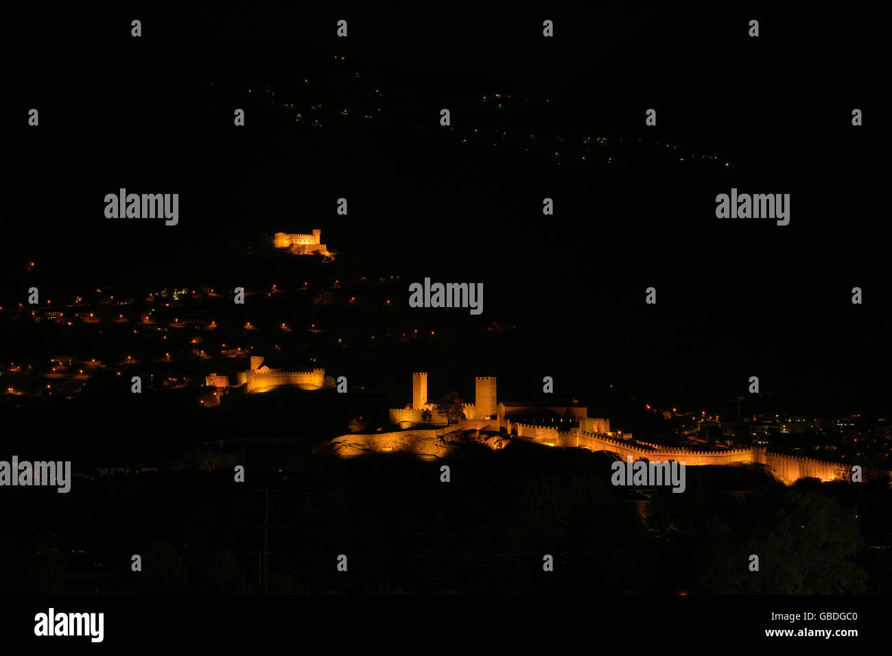 Los tres castillos de Bellinzona (Castelgrande, Montebello, Sasso Corbaro) por la noche. Cantón de Ticino, Suiza. Foto de stock