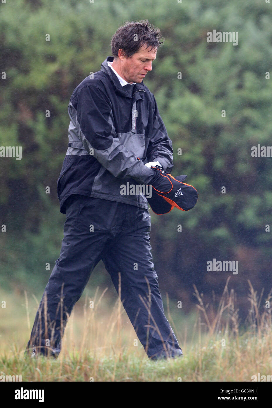 El actor Hugh Grant durante un día de práctica bajo la lluvia en el campo de golf Kingsbarns, antes del Alfred Dunhill Links Championship que comienza el jueves. ASOCIACIÓN DE PRENSA Foto. Foto fecha: Martes 29 de septiembre de 2009. El crédito de la foto debe decir: Andrew Milligan/PA Wire Foto de stock