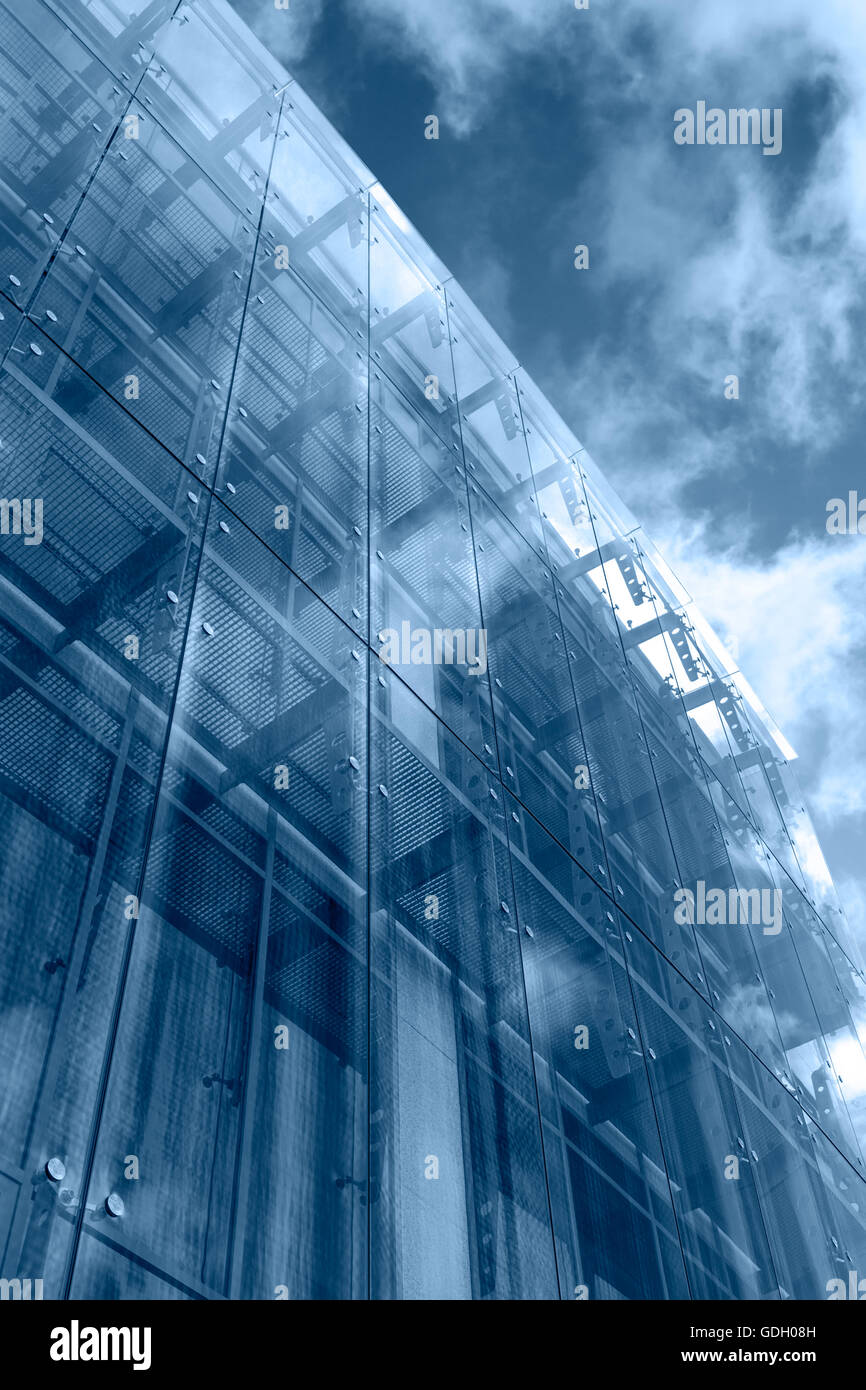 El cielo y las nubes reflejados en un moderno edificio con fachada de cristal Foto de stock