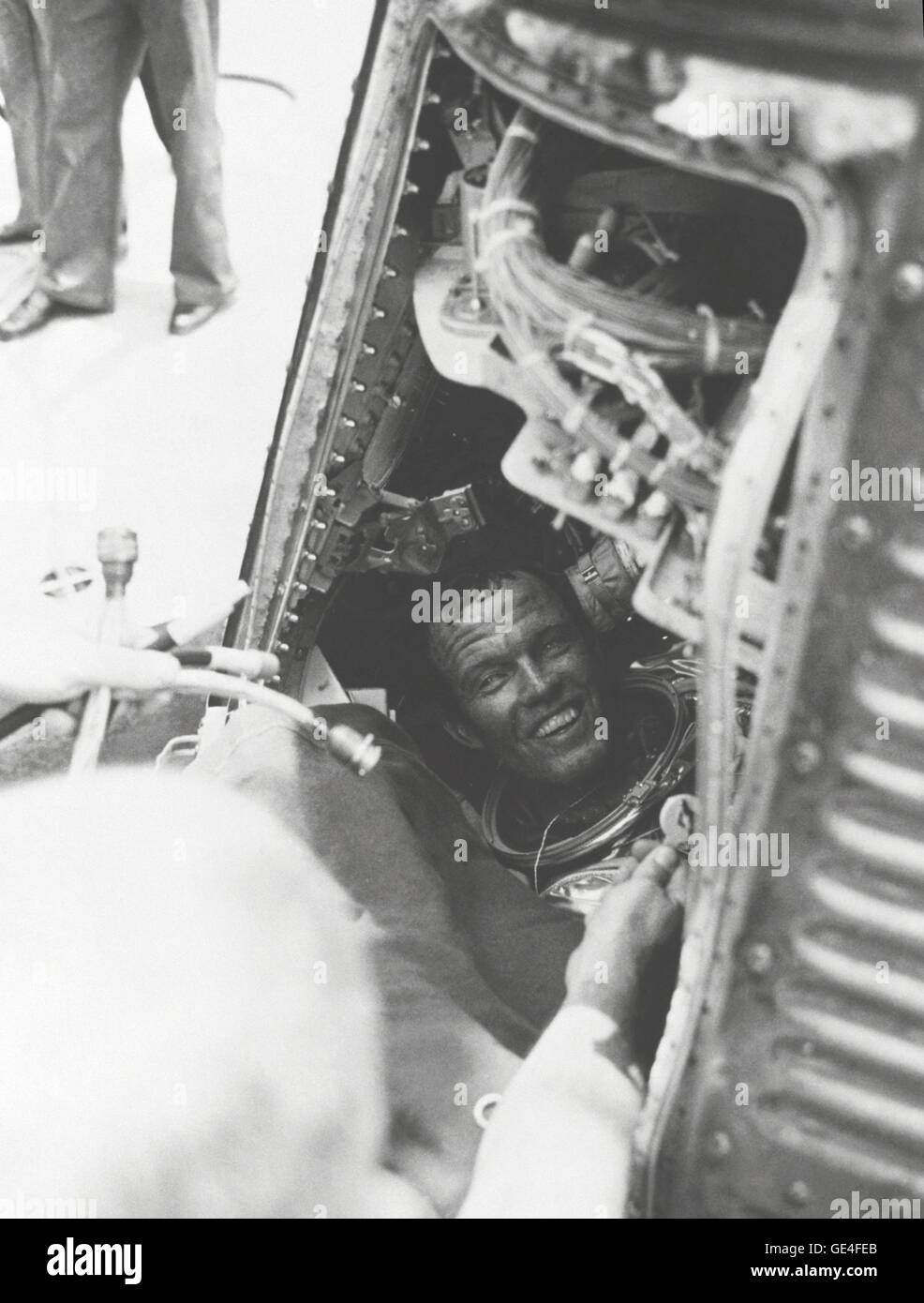 L. astronauta Gordon Cooper Jr., tiene una sonrisa para la recuperación de la tripulación del U.S.S. Kearsarge, después de que él está a bordo de un exitoso 22 misión orbital de la Tierra en su nave espacial de mercurio "Fe 7." Cooper todavía está sentado en su cápsula, con su casco. Imagen # : S63-07852 Fecha: Mayo 16, 1963. Foto de stock