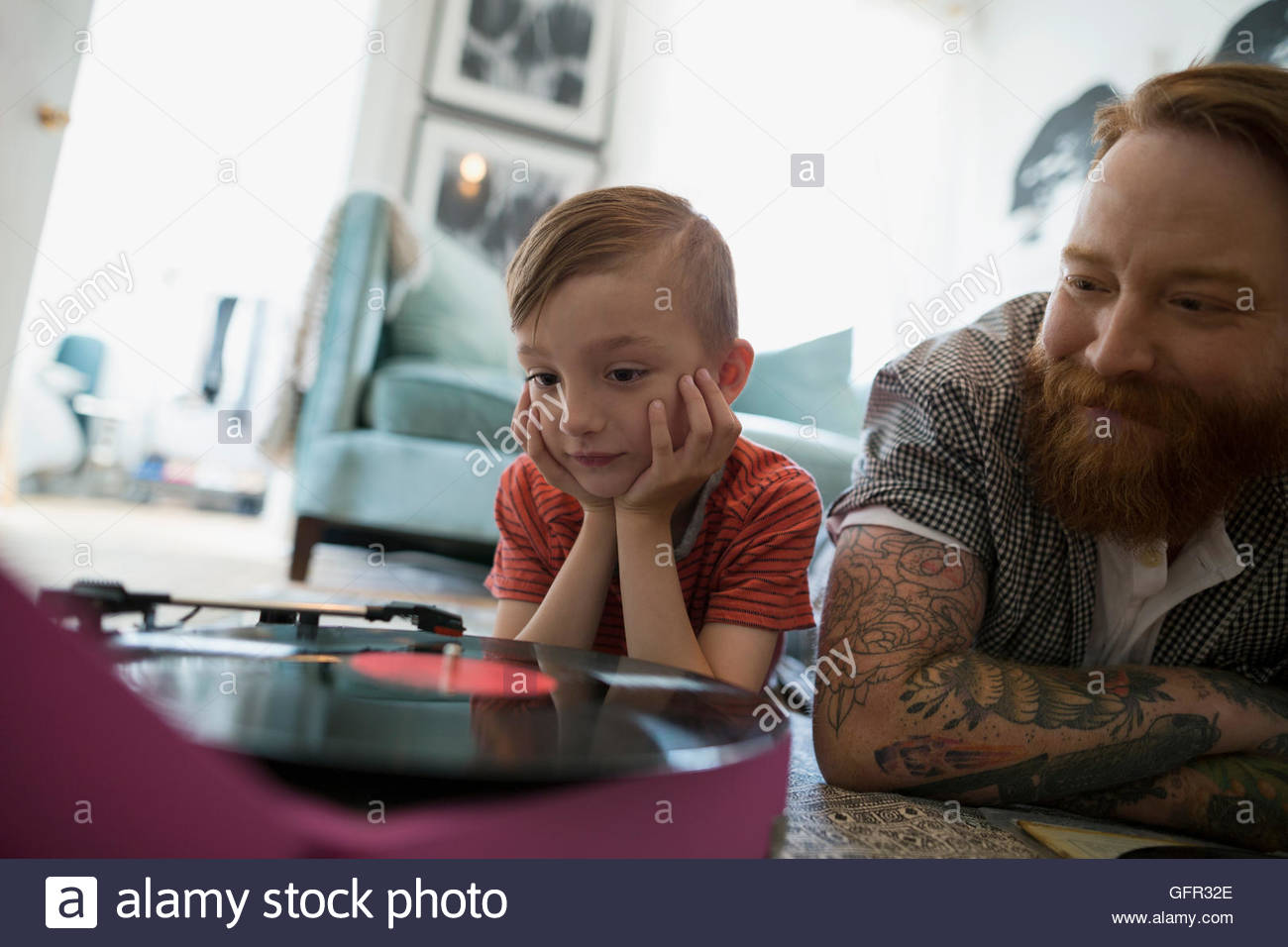 Padre e hijo curioso jugar registro en jugador de registro Foto de stock