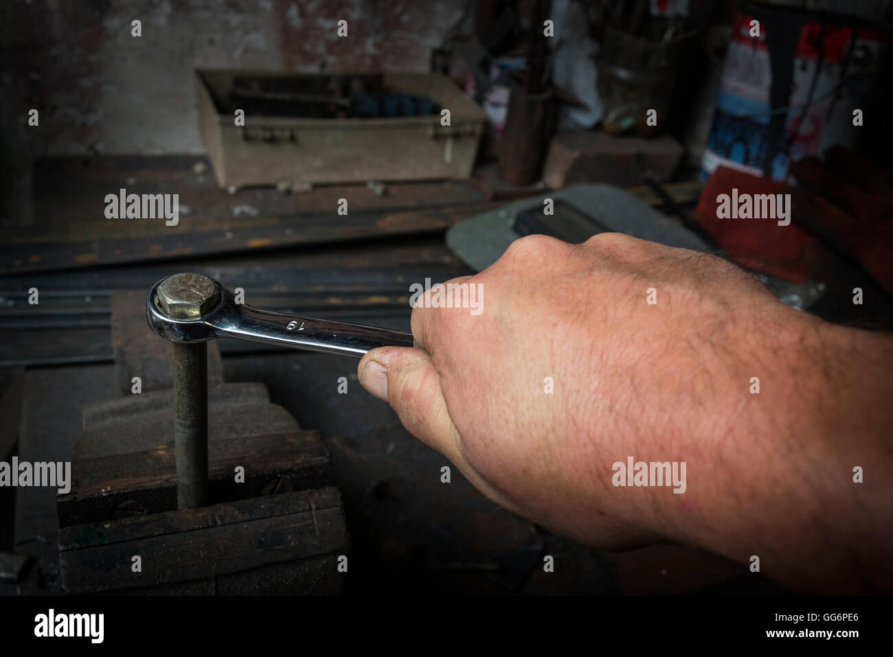Trabajador mano apretar o aflojar una de un tornillo oxidado con una llave en el viejo Fotografía de Alamy