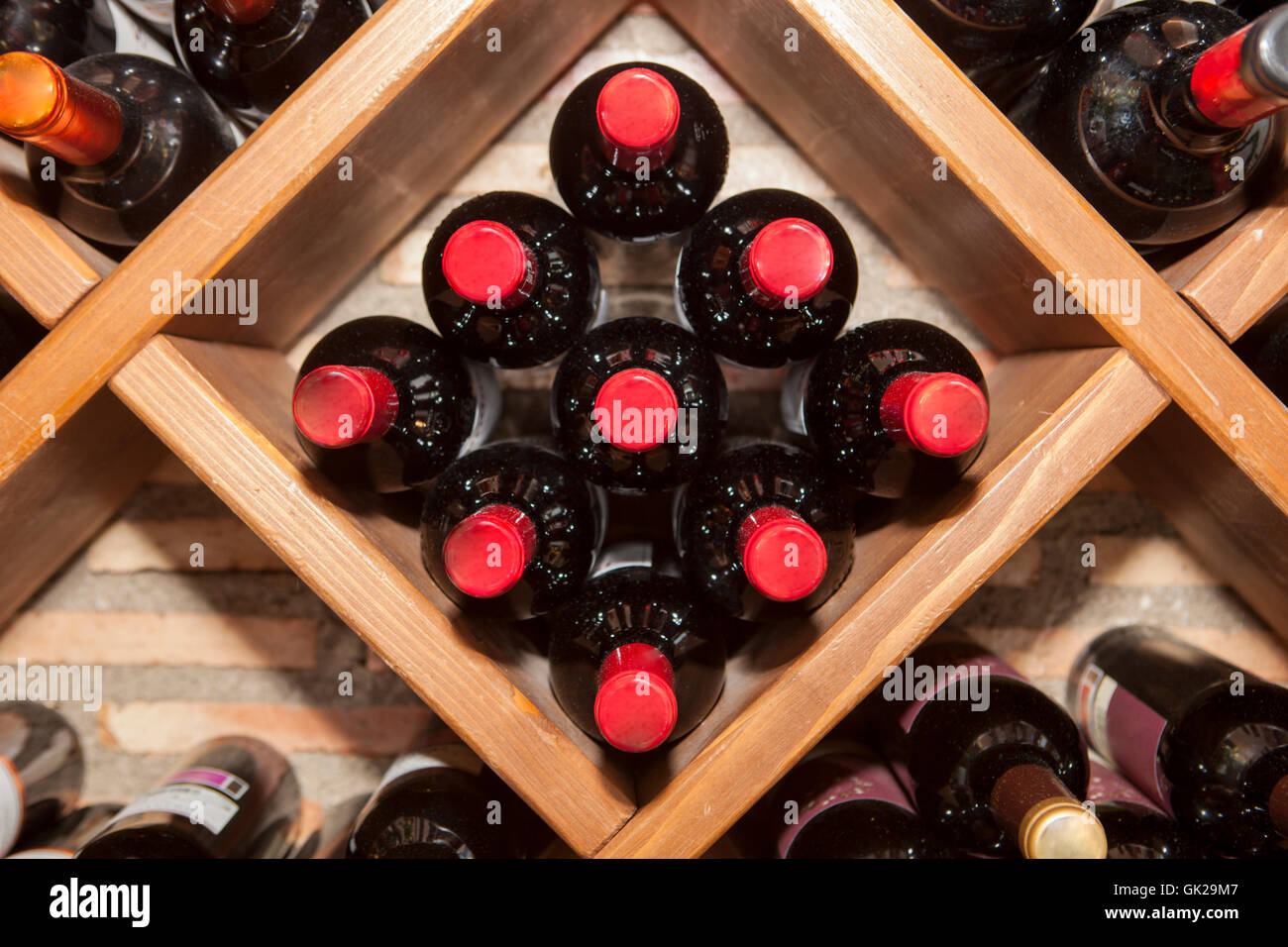Estante de vino romboidal con varias botellas de vino tinto español tumbado  en el almacenamiento Fotografía de stock - Alamy