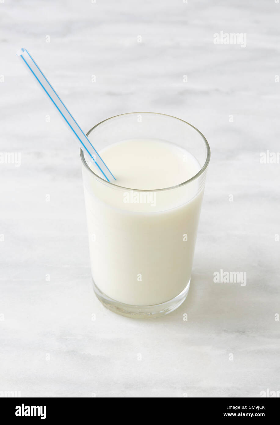 Vaso de leche con paja potable Foto de stock