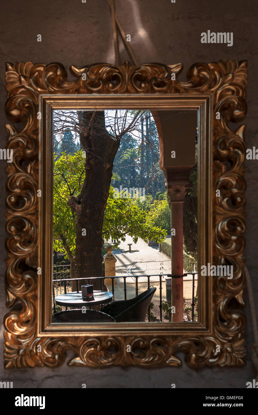 Vista del jardín del Marqués de la Vega-Inclán, reflejada en un espejo de pared elaboradas, Jardines Real Alcázar, Sevilla, España Foto de stock