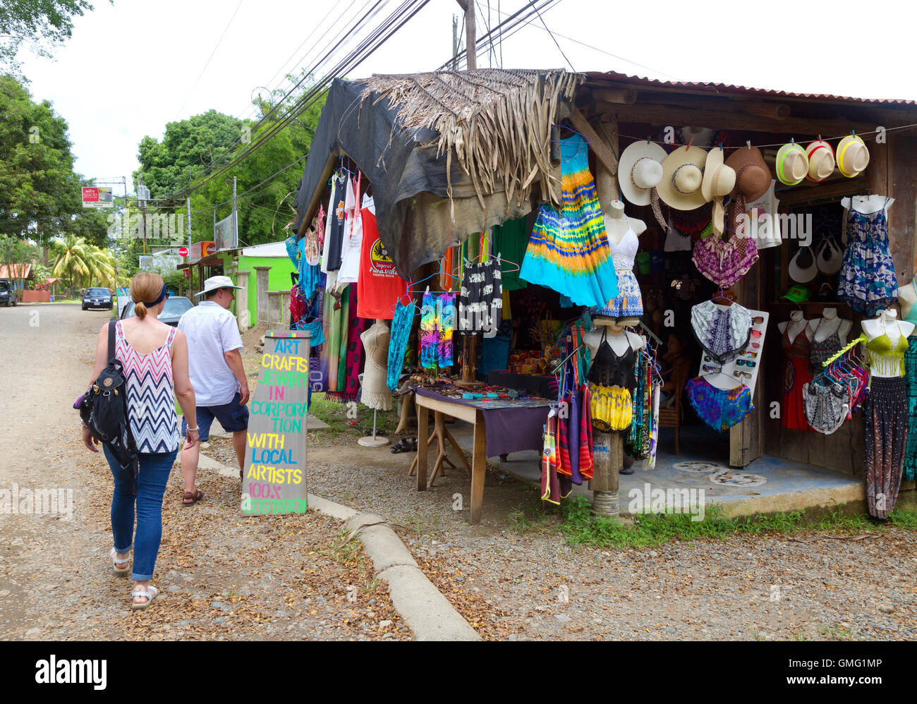 Una pareja de turistas entrando en una tienda de regalos, Dominical village, Costa Rica, Centroamérica Foto de stock