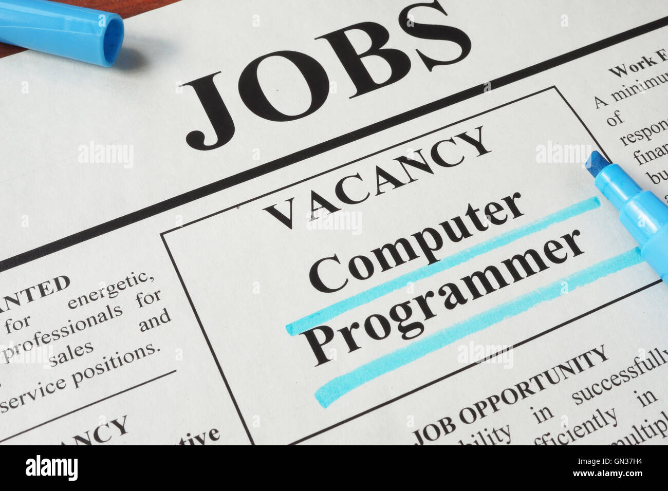 Periódico con anuncios de vacantes para programador de computadoras. Concepto de empleo. Foto de stock
