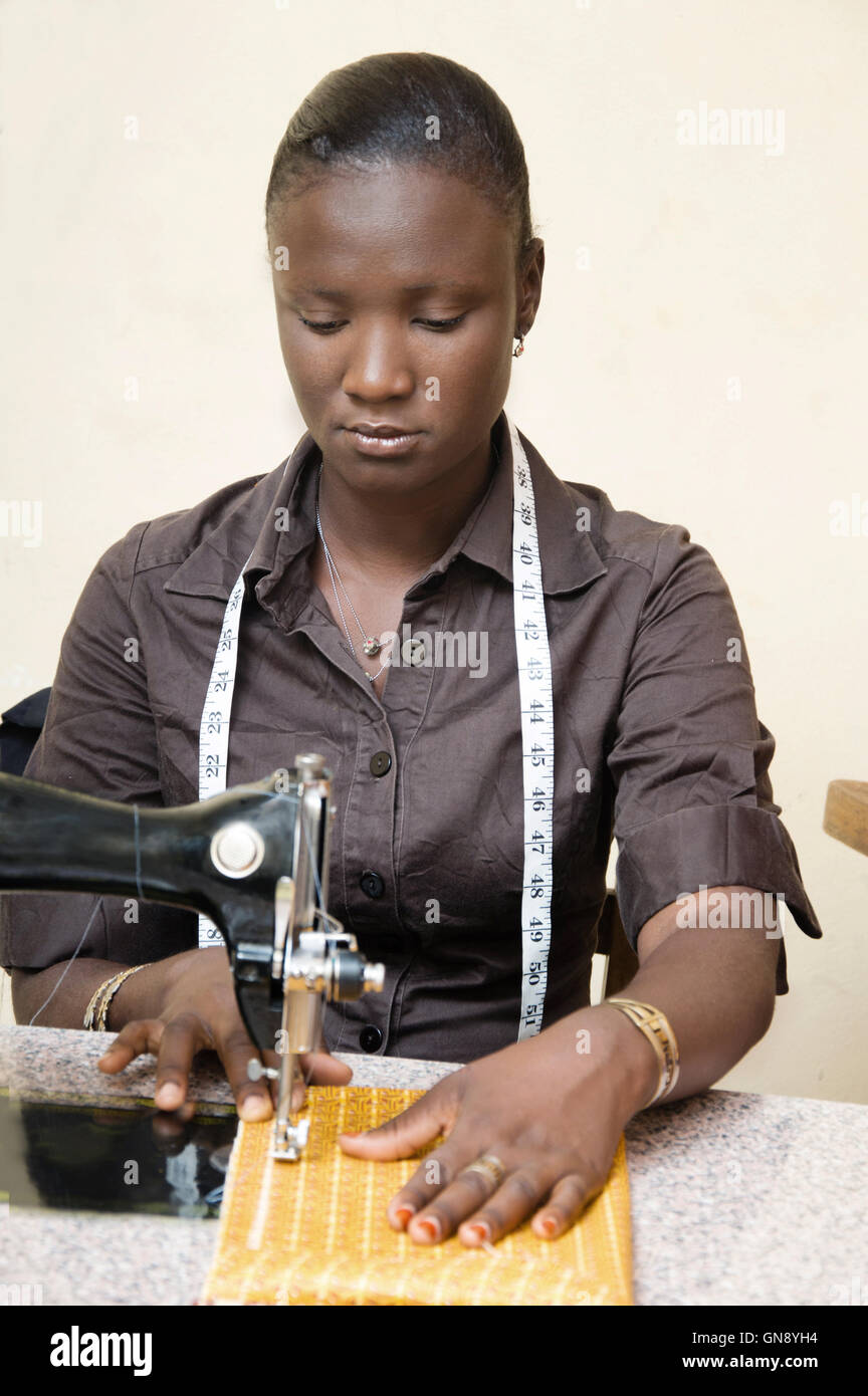 Mujer joven seamtresssitting , centrado en su trabajo es coser un taparrabos Foto de stock