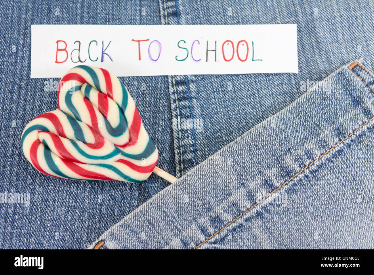Lollipop en denim blue jeans pocket Foto de stock