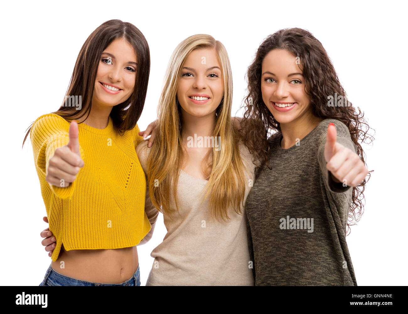 Retrato de estudio de tres chicas adolescentes con pulgares hacia