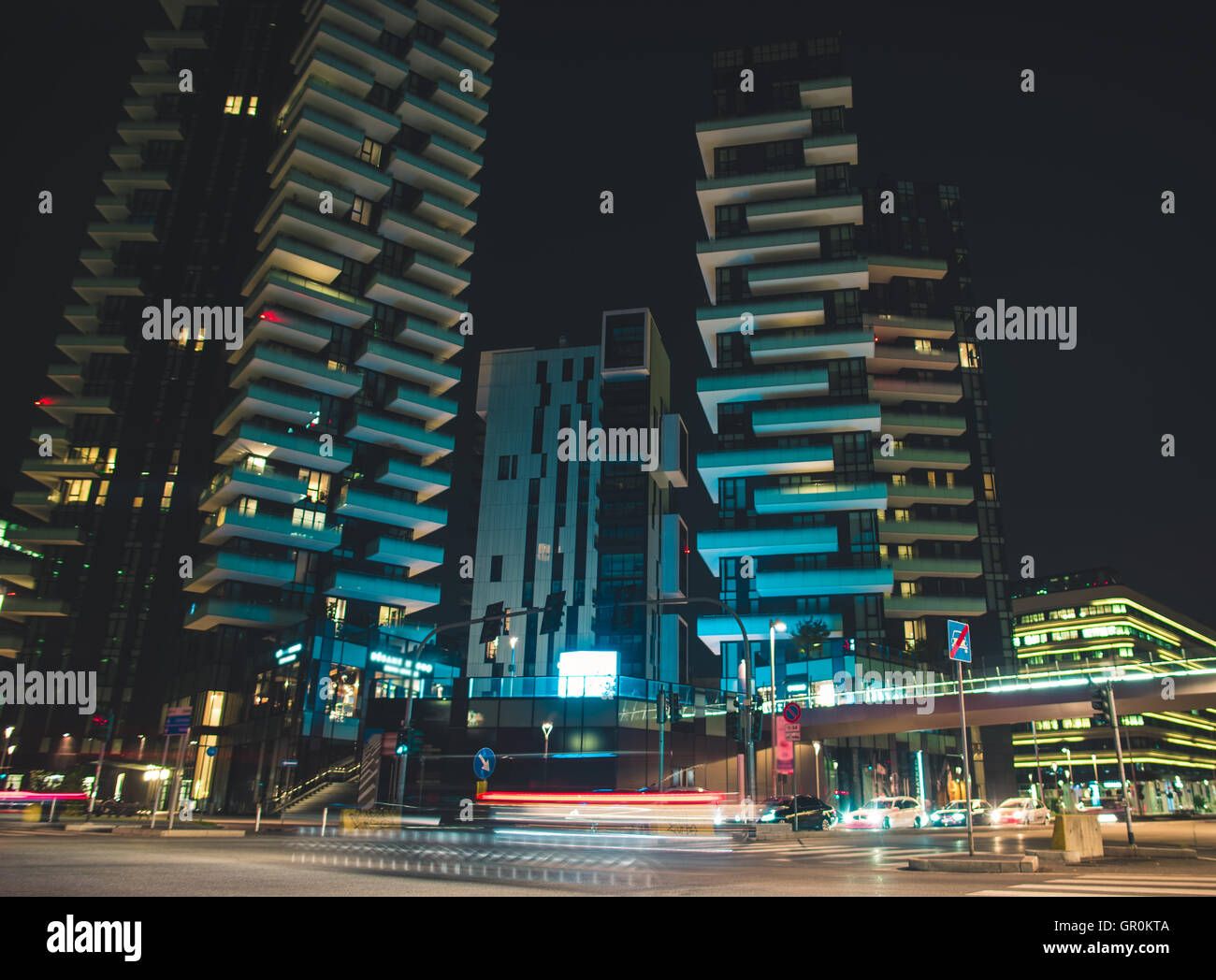 Tráfico rápido y rascacielos de la ciudad moderna ocupado por la noche Foto de stock
