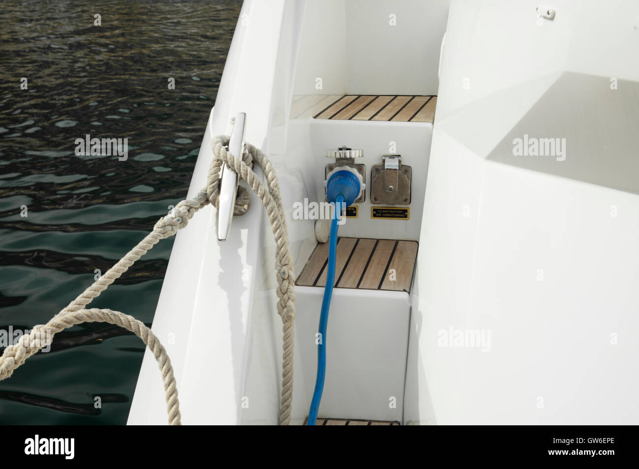Detalle del cable eléctrico enchufado en el barco de un generador auxiliar Foto de stock