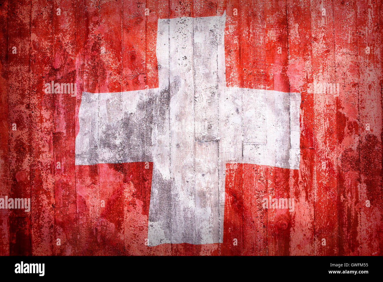 Grunge estilo de Suiza bandera en una pared de ladrillos en el fondo Foto de stock