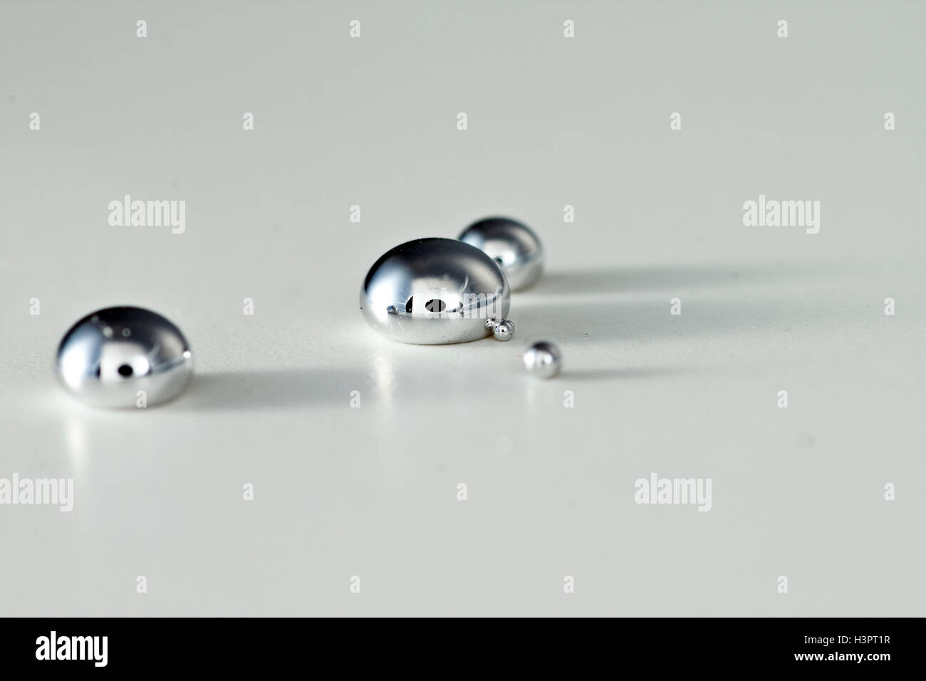 Gotas de mercurio líquido sobre una superficie dura. Mercurio tiene un  punto de fusión muy bajo, y es el único metal que es líquido a temperatura  ambiente y estándar Fotografía de stock 