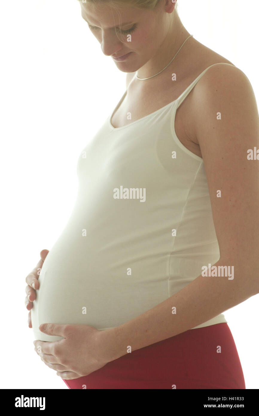 Mujer embarazada, la mano, el abdomen, de sentir, de detalle, embarazada, 20-30 años, 8 meses de gestación, abdomen, prejoy libremente, alegría, feliz, la alegría de la maternidad, sentimiento, emoción, naturalidad, optimismo, orgullo, humor, positivamente Foto de stock
