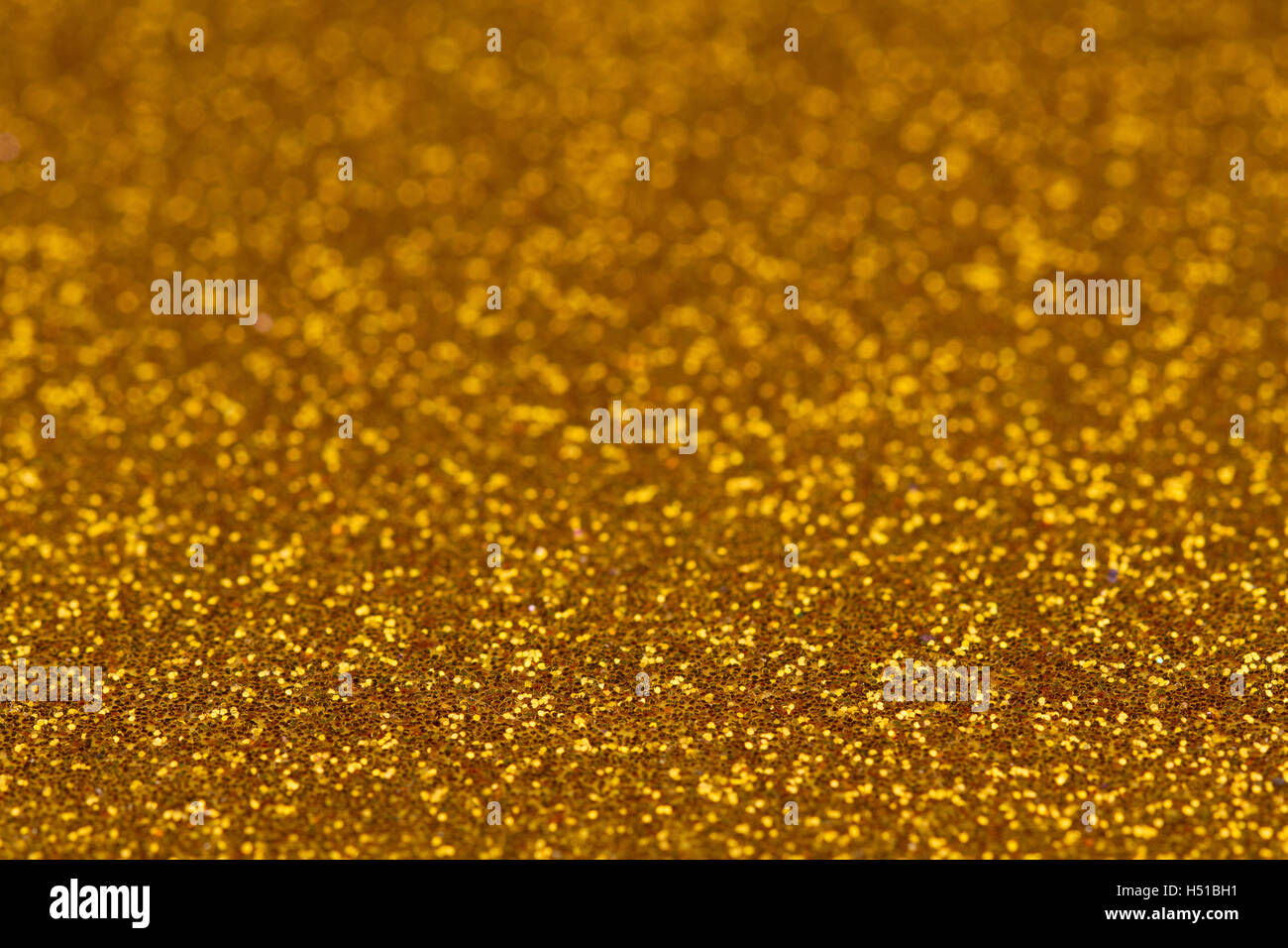 Glitter horizontal de color dorado con textura de fondo borroso de la  profundidad de campo Fotografía de stock - Alamy