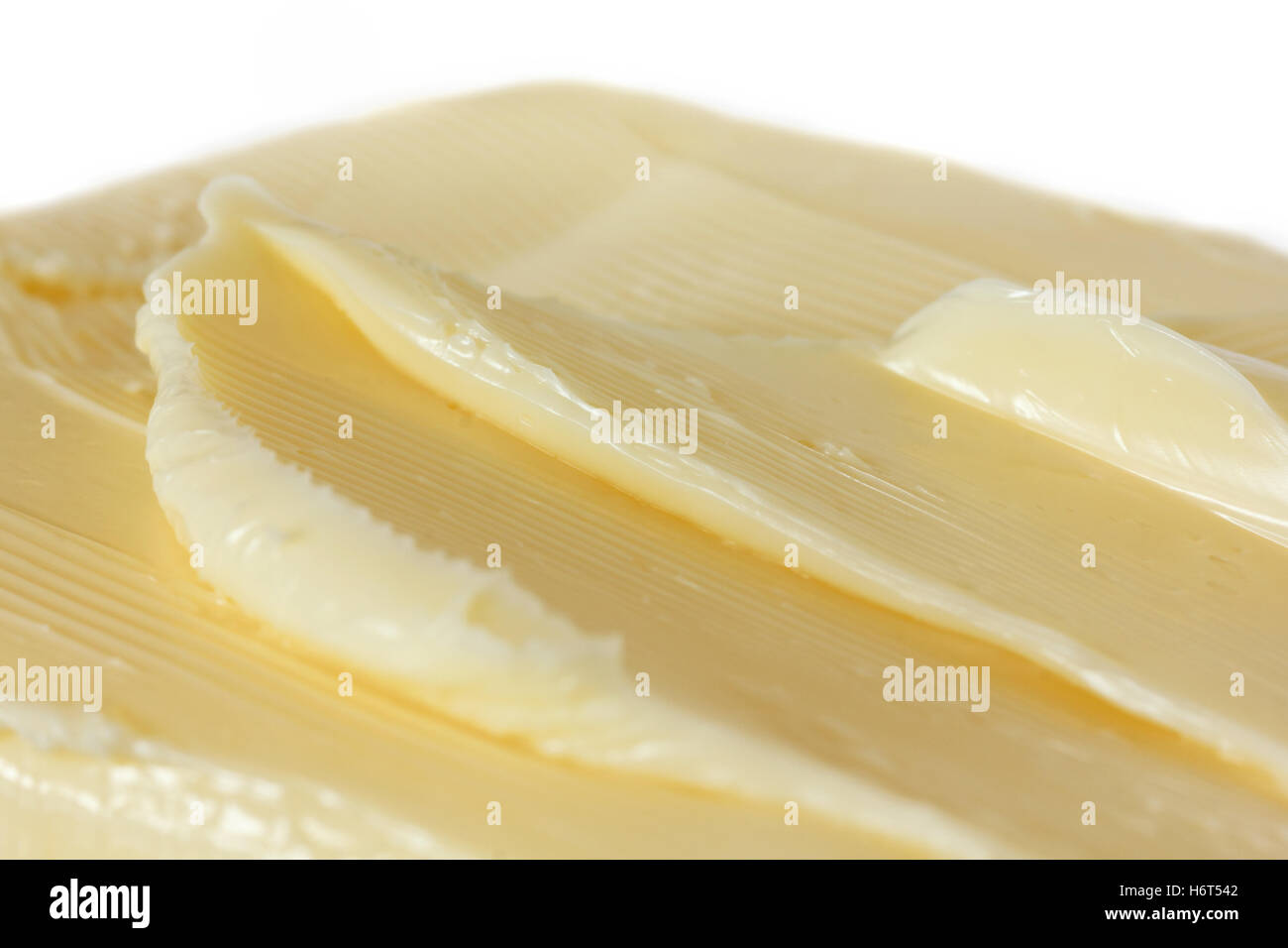 Mantequilla blanda diseminado en una forma abstracta Foto de stock