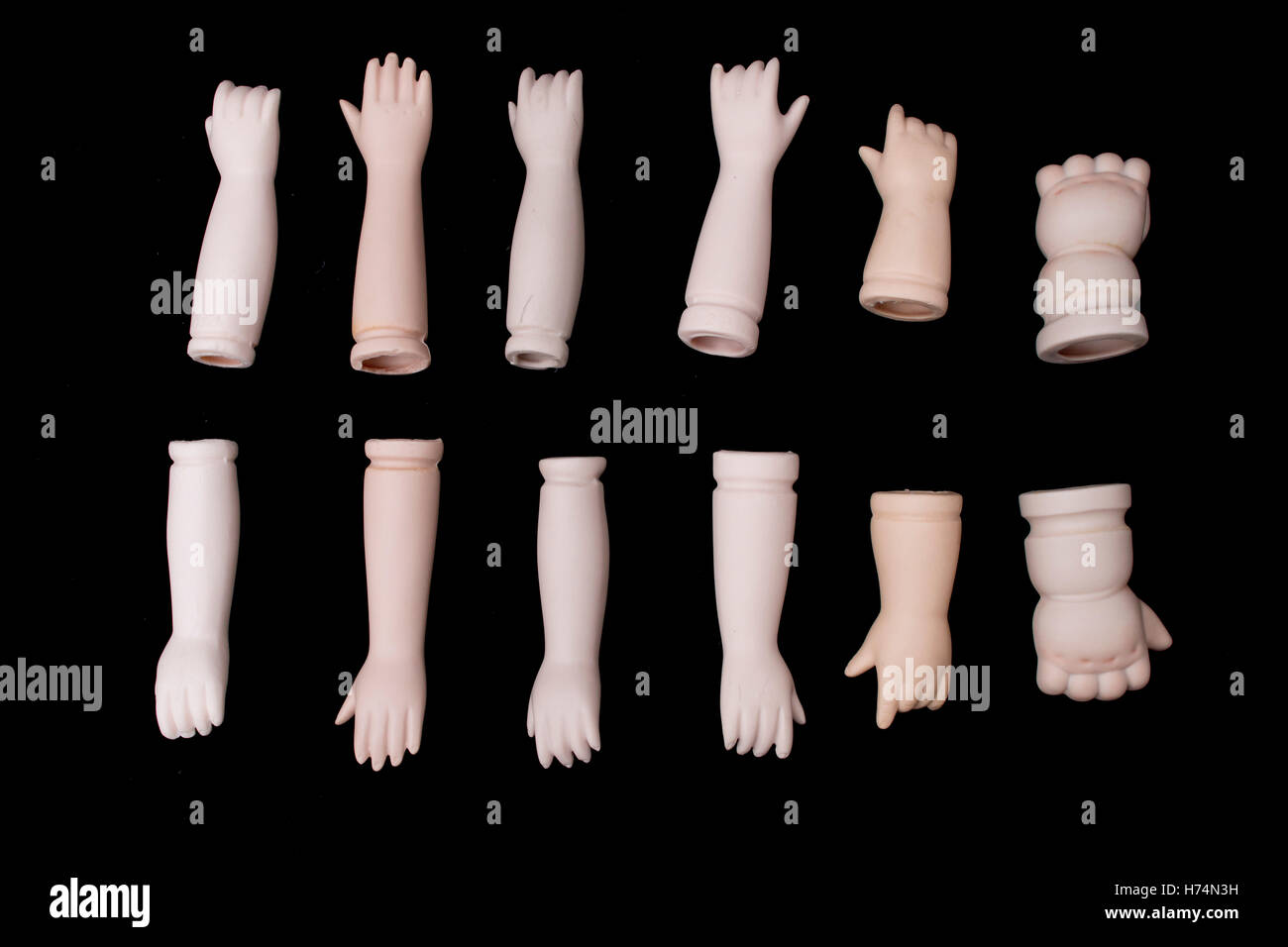 Las partes del cuerpo de muñecas rotas de manos y brazos sobre fondo negro  Fotografía de stock - Alamy