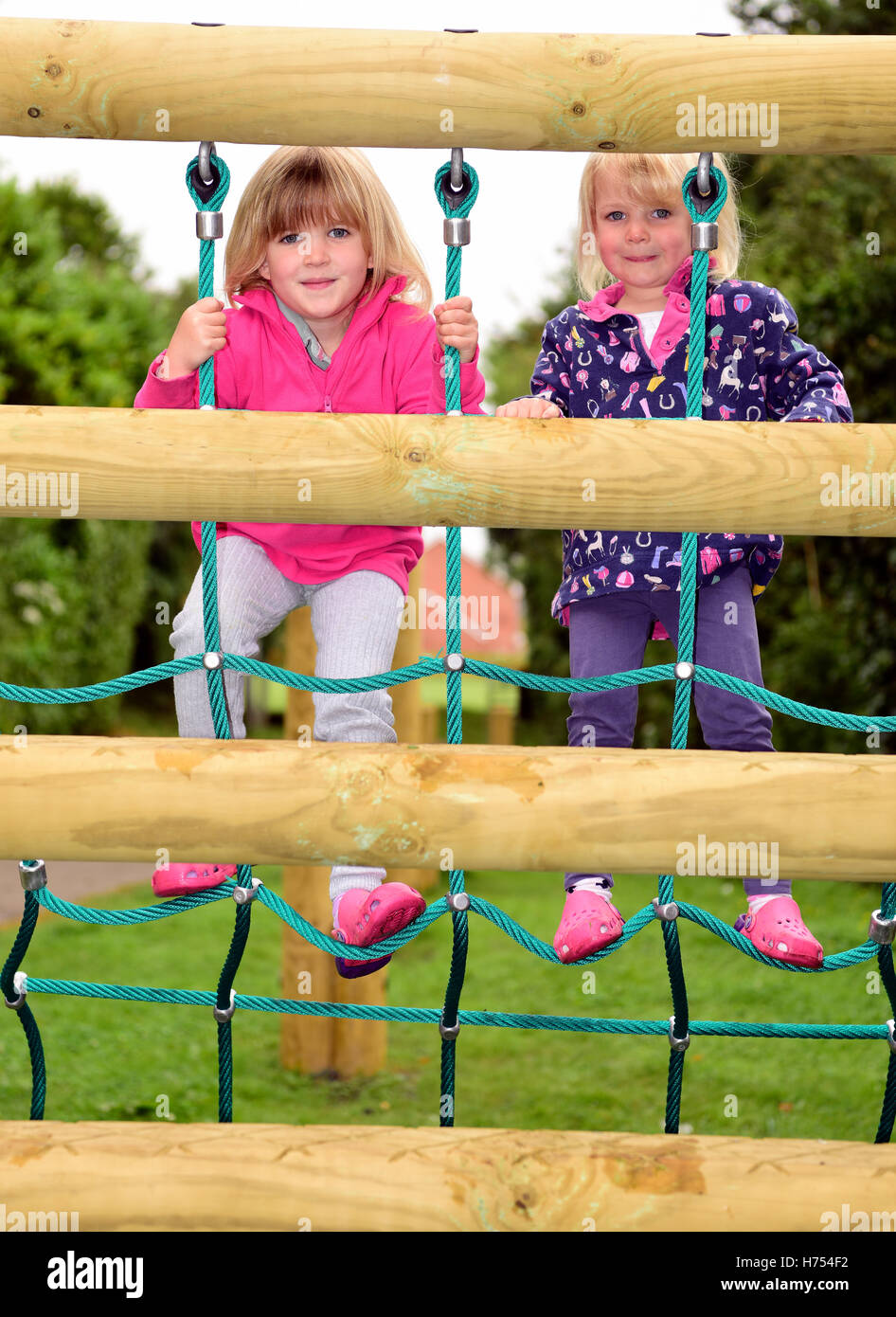 Dos jóvenes (6 y 3 años) utilizando las instalaciones recreativas, cuatro marcas, cerca de Alton, Hampshire, Reino Unido. Foto de stock