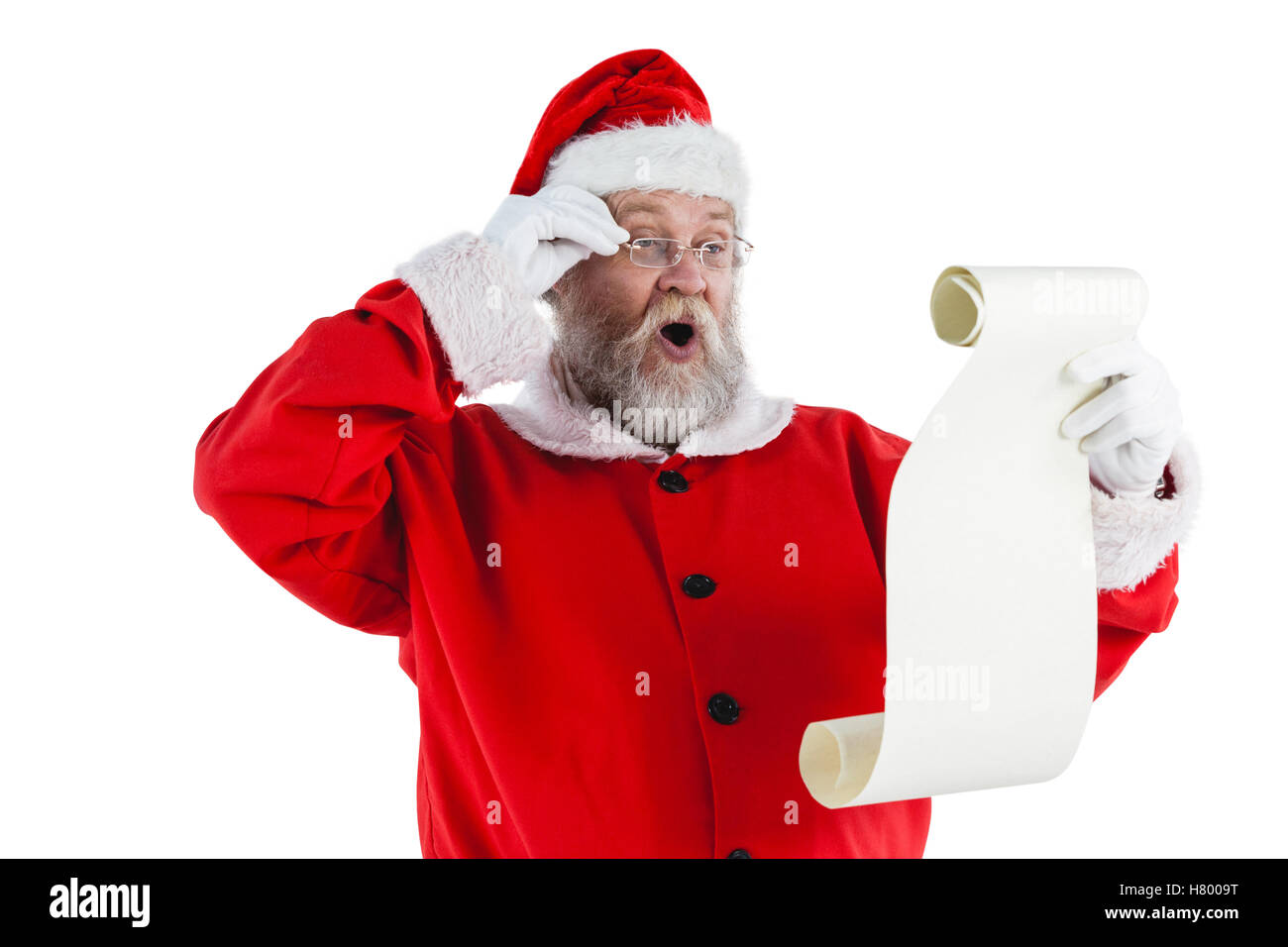 Santa Claus haciendo la expresión facial mientras leía desplazarse Foto de stock