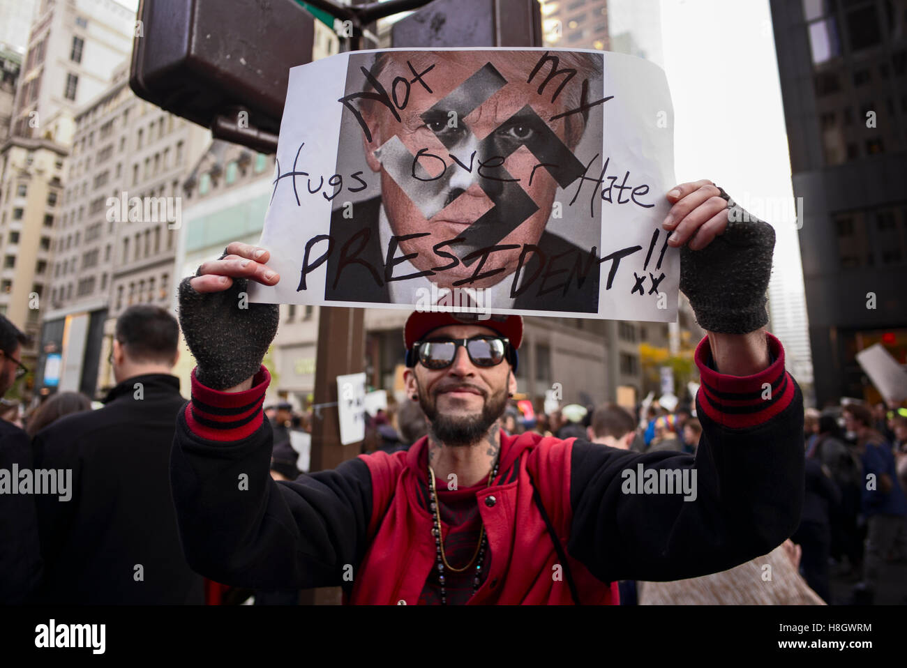 Nueva York, Estados Unidos. El 12 de noviembre de 2016. Un hombre sostiene un anti-Donald Trump firmar durante una marcha desde la Ciudad de Nueva York hasta Union Square 5th Avenue a la Torre Trump, para protestar contra la elección de Trump como 45º presidente de los EE.UU. Crédito: Joseph Reid/Alamy Live News Foto de stock