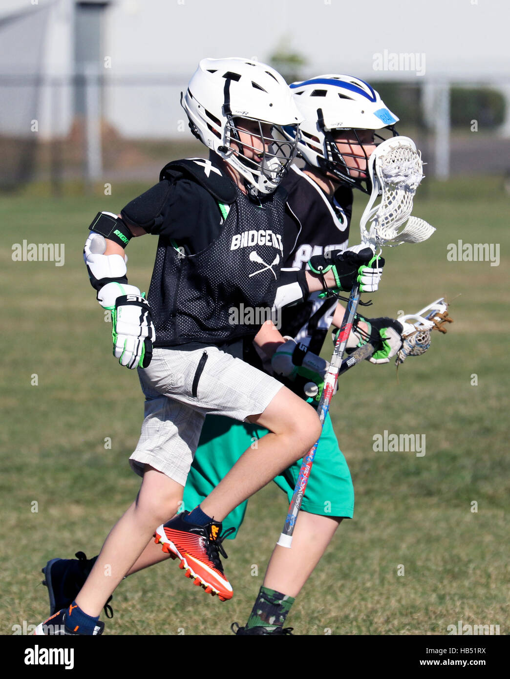 Dos muchachos de 10 años jugando Lacrosse. Foto de stock