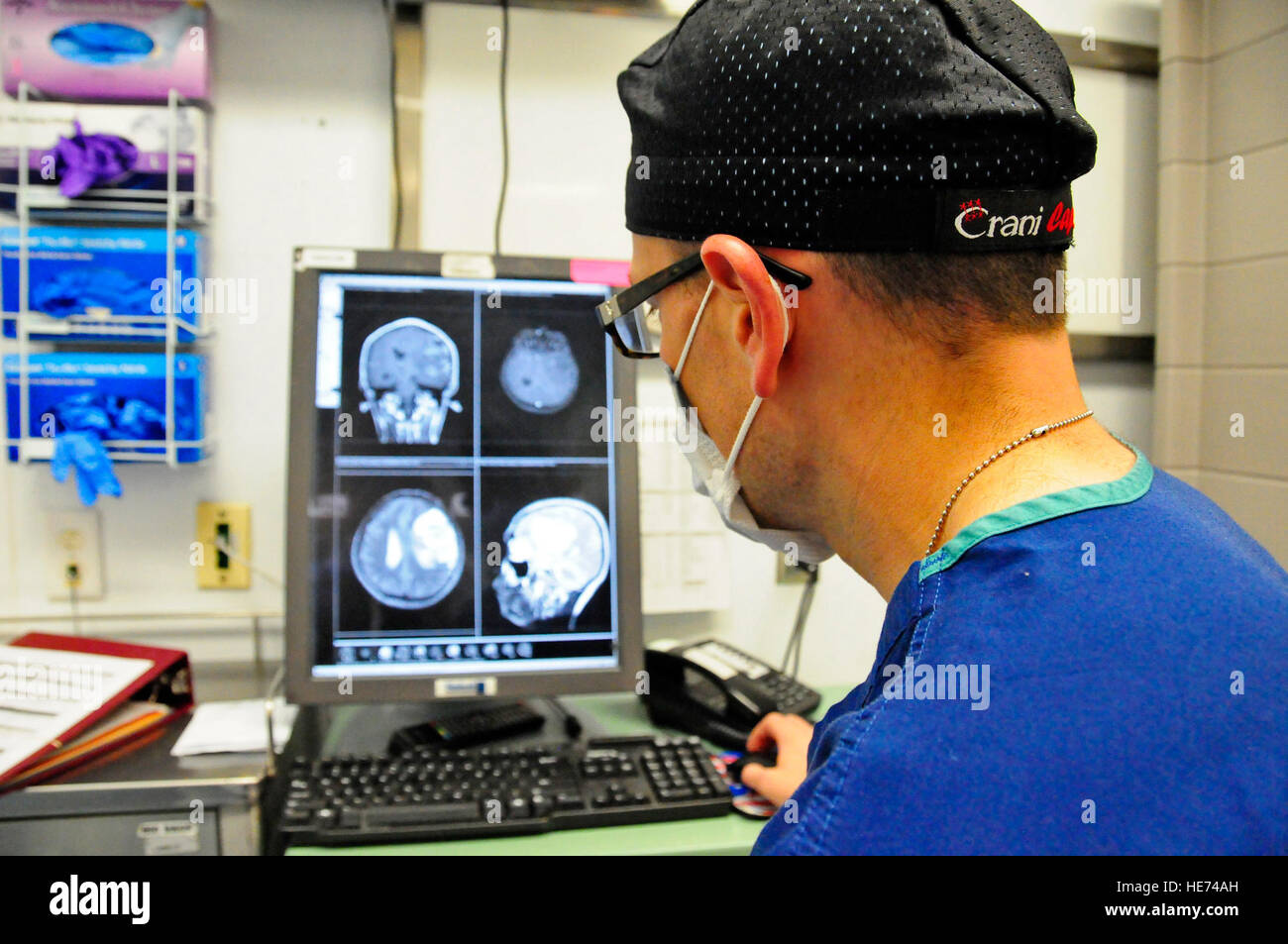 La Fuerza Aérea de los EE.UU Maj Jonathan Forbes, 455 Expedicionaria Escuadrón de Operaciones Médicas neurocirujano comentarios la resonancia magnética de un paciente antes de realizar una cirugía cerebral en el Hospital de teatro conjunta de Craig, Bagram Air Field, Afganistán, 10 de octubre de 2014. Forbes extraído un tumor de 8 centímetros en la cirugía que duró 5 horas. Forbes es de Travis Air Force Base, California El Sargento. Miguel Lara III Foto de stock