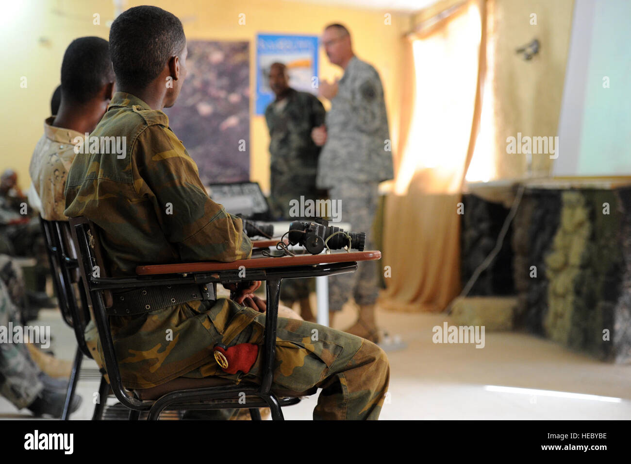 Soldados del ejército yibutino escuchar durante una clase de gafas de visión nocturna en Arta, Djibouti, el 23 de marzo de 2012. El ejército de los EE.UU. el 3º Escuadrón, 124º Regimiento de Caballería, desplegados en apoyo de la Combined Joint Task Force - Cuerno de África (CJTF-HOA), está ayudando a entrenar soldados del ejército de Djibouti para un próximo despliegue a Somalia. Foto de stock