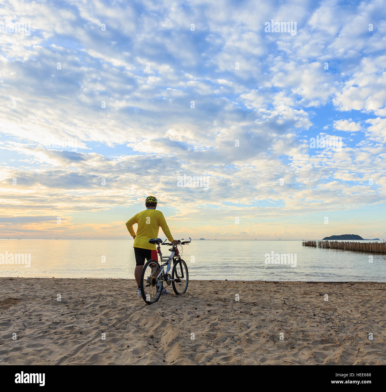 Ciclista con bicicleta en el Sunrise Beach Foto de stock