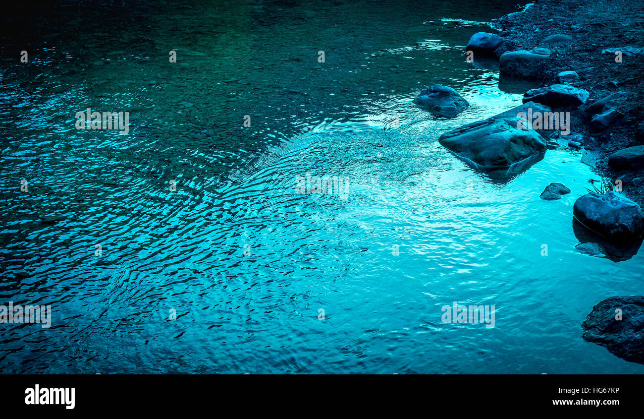 El agua del río tranquilo en la luz de la tarde Foto de stock