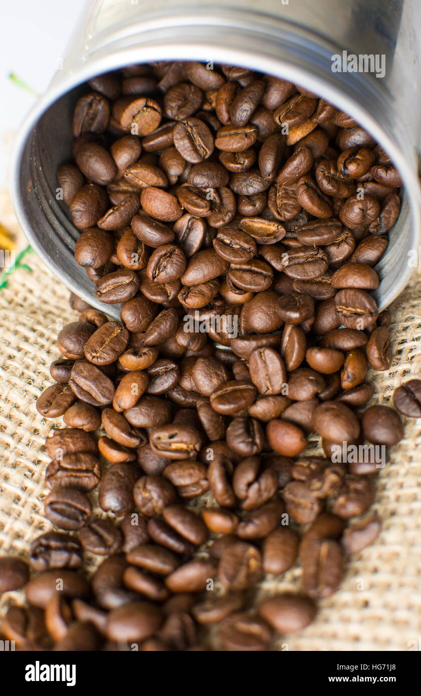 Café tostado en grano cae de metal puede Foto de stock