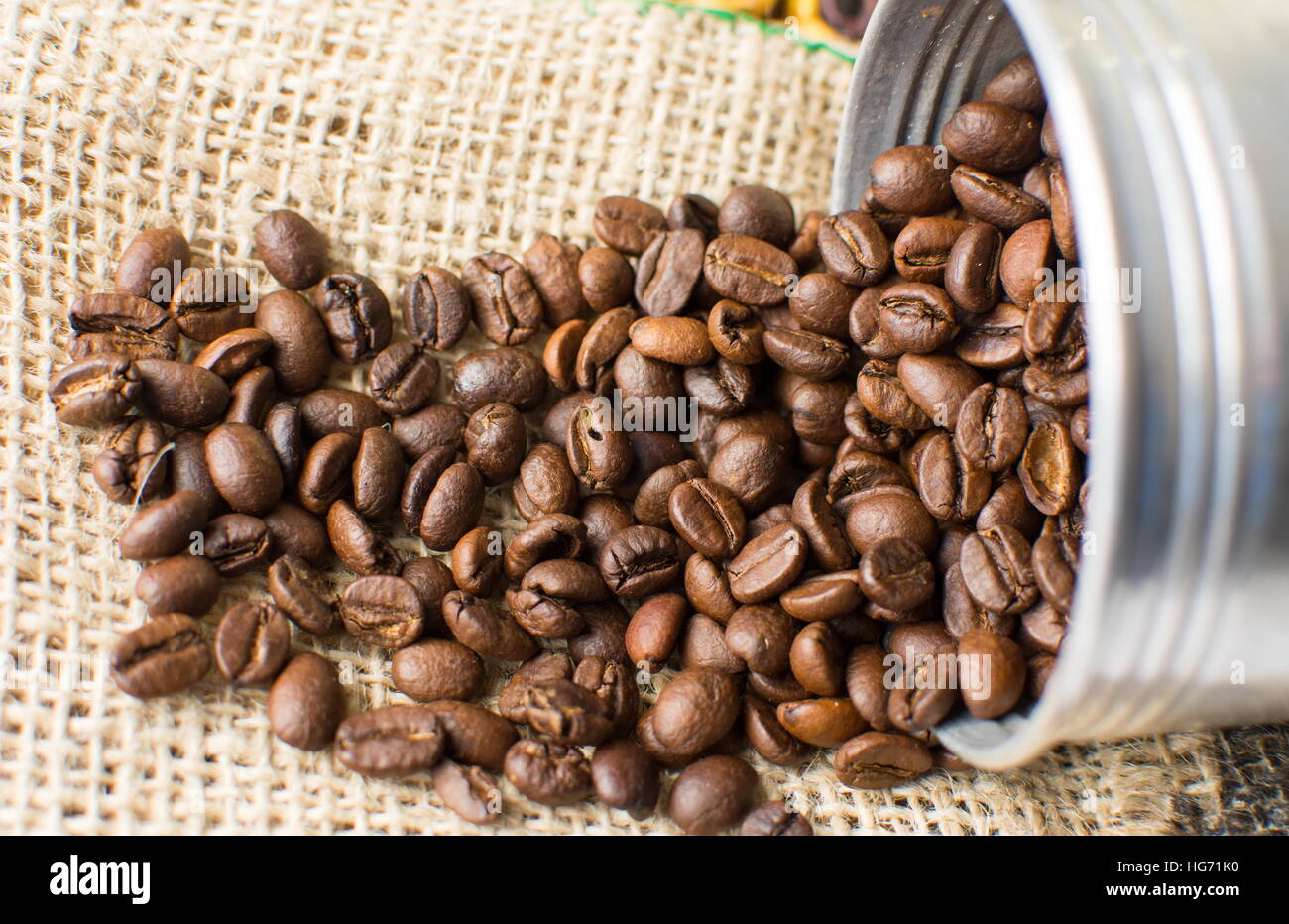 Café tostado en grano cae de metal puede Foto de stock