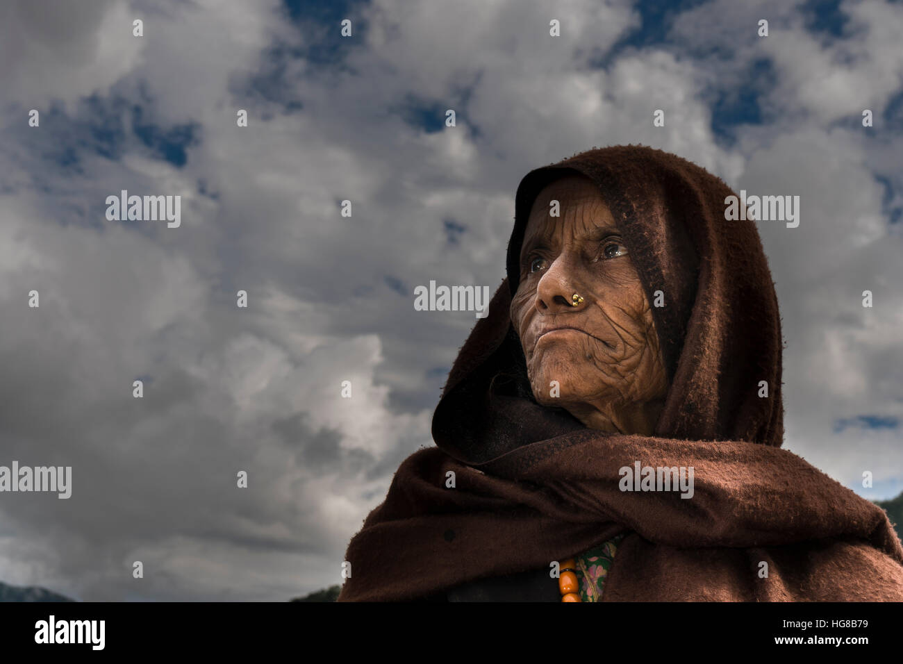 Retrato de una mujer local arrugado, viejo, llevaba una bufanda marrón, Ghandruk, distrito de Kaski, Nepal Foto de stock