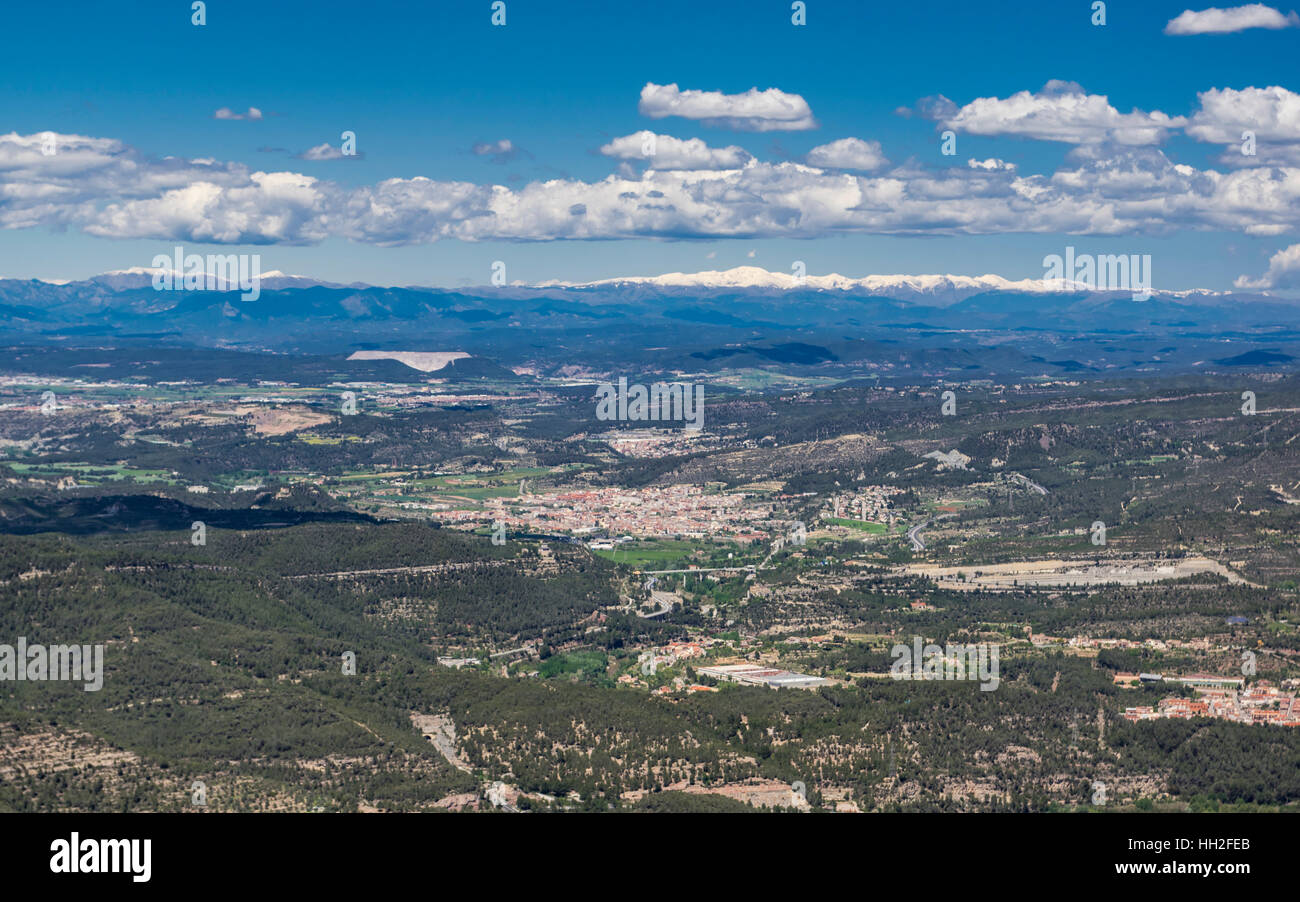 Vista de Montserrat a la localidad de Sant Vicenç de Castellet y las cumbres nevadas de los Pirineos. Cataluña, España. Foto de stock